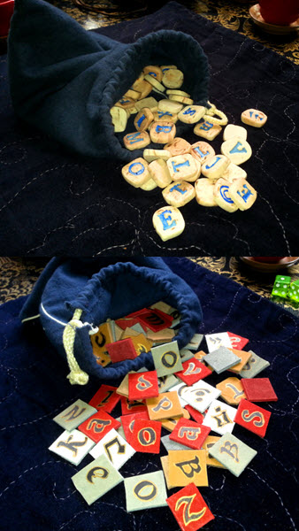 Two blue flannel bags with tiles of leather and plasticine calling from their openings